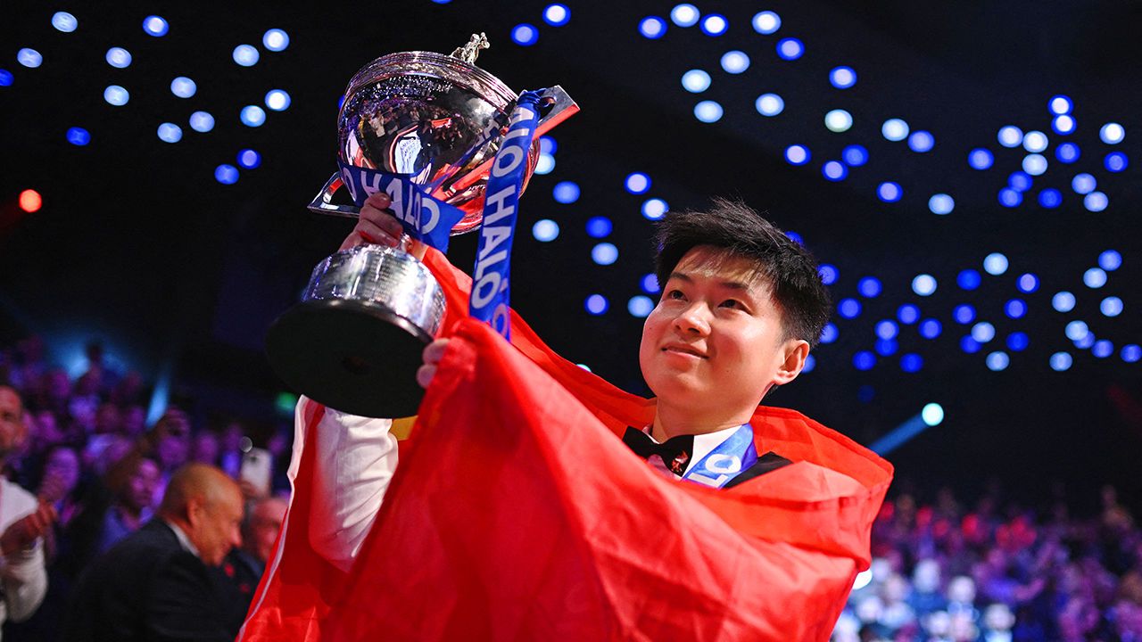 China's Zhao Xintong poses with the trophy after winning The World Championship Snooker final