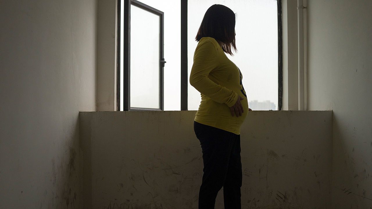 A pregnant woman who is acting as a surrogate in Wuhan.