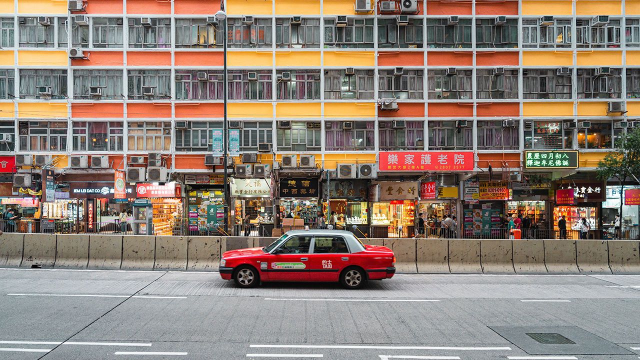 A taxi driving along King's Road, Hong Kong