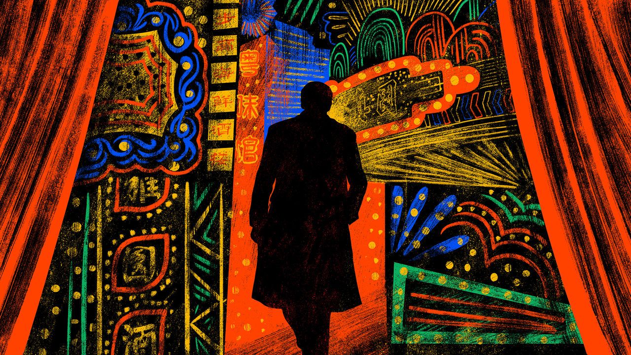 The dark figure of a man silhouetted against the colourful bright lights of Shanghai