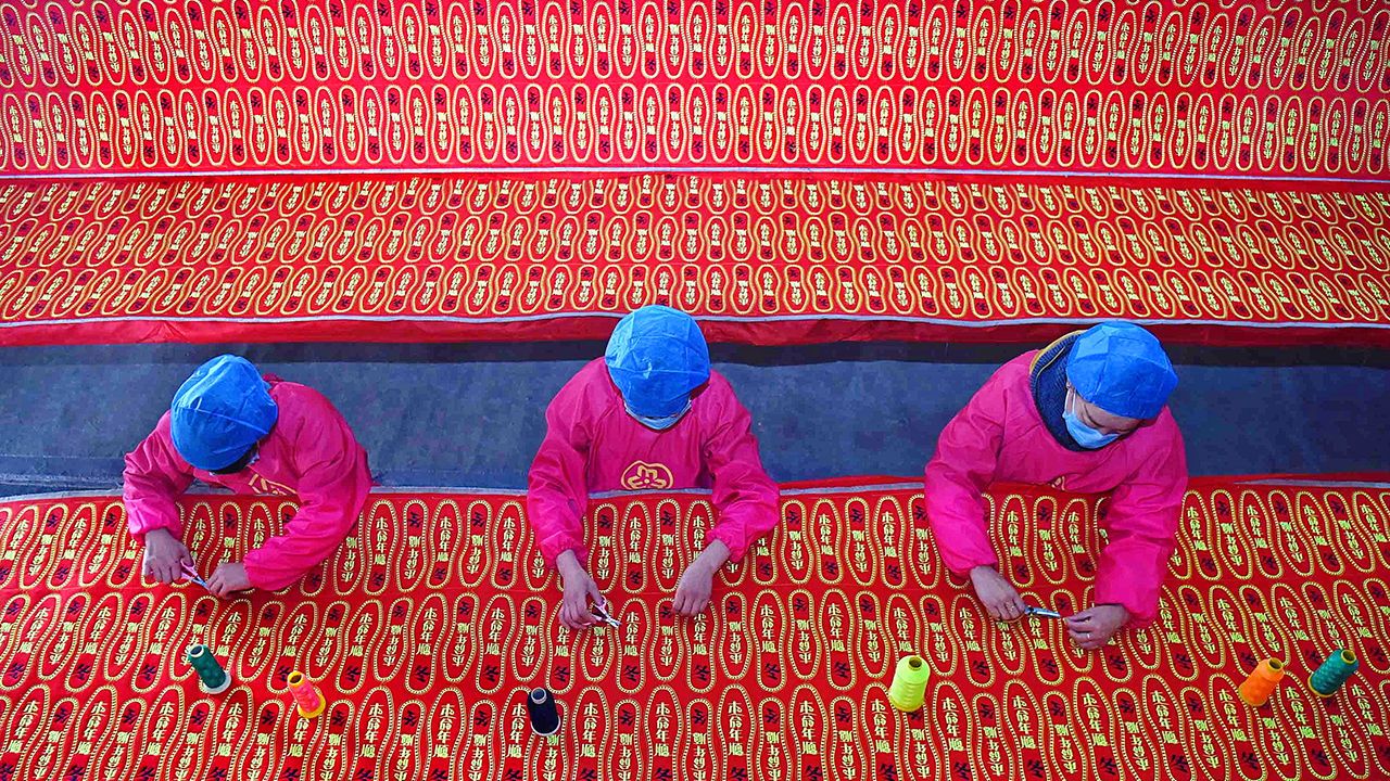 Aerial view of three workers making shoe insoles at a factory in Buxia Village of Nanma Subdistrict in Yiyuan County, Zibo, east China's Shandong Province.