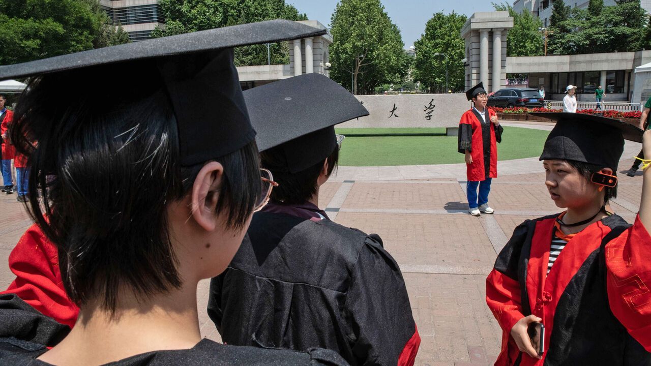 Graduates at the gates of Tsinghua University, Beijing.