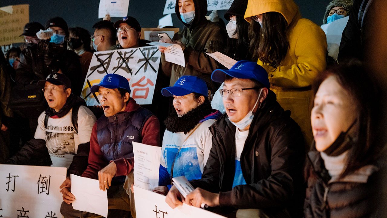 Chinese protesters rally against harsh covid restrictions and the treatment of Uighur people near the Chinese Consulate in New York City