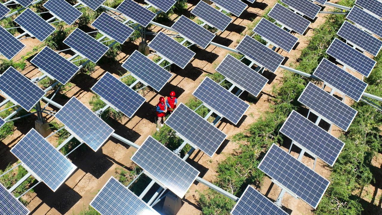 Workers carrying out a photovoltaic module inspection and electricity service in Yinchuan, China.