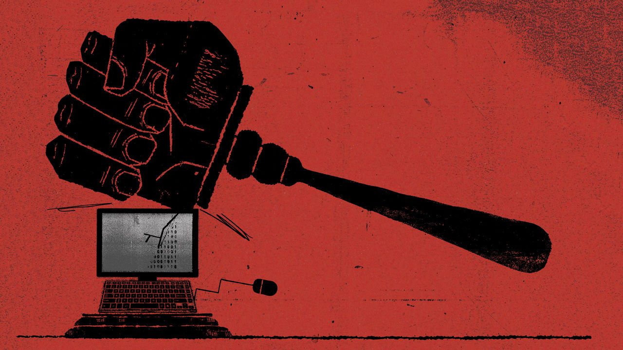 A giant fist-shaped gavel coming down onto a computer and cracking the screen